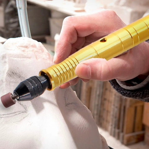 Gold One Eighth Inch Flex Shaft Adapter For Rotary Tools Pro Grade Flexible Shaft Attachment in use on sculpture