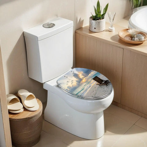 Elongated deck chair sandy beach waters edge seas Toilet Seat on a modern white toilet with sunset view design.