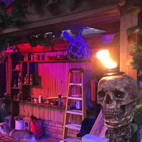 Skull Tiki Torch Set For Halloween Yard Decor, Handcrafted Skull Pattern Outdoor Lights illuminating a patio area, installed view.