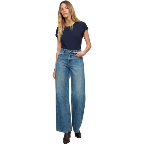 Head Turner High Rise Wide Leg Jeans For Women In Hush Color With Zip Fly And Button Closure Classic Five Pocket Design 32Inseam 100 Percent Cotton Flattering Silhouette For Bold Everyday Style. model wearing wide-leg jeans, high-rise waist, 32 inseam, 100% cotton