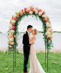 Two Form Outdoor Garden Arch Trellis Made From Sturdy Steel For Climbing Plants Great For Weddings And Yard Decor Weather Resistant No Fuss Setup Black 94 Inch Tall And 55 Inch Wide Or 96 Inch Wide To Fit Any Space with couple kissing under floral arch by the lake
