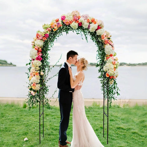 Two Form Outdoor Garden Arch Trellis Made From Sturdy Steel For Climbing Plants Great For Weddings And Yard Decor Weather Resistant No Fuss Setup Black 94 Inch Tall And 55 Inch Wide Or 96 Inch Wide To Fit Any Space with couple kissing under floral arch by the lake