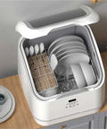 Top Notch Compact Countertop Dishwasher With High Temp Wash And Rapid Air Dry Tech Designed For Tiny Apartments While Crushing Daily Grease Without Breaking A Sweat, open with dishes and utensils inside.