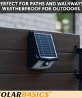 Two Pack Solar Security Lights With Motion Sensor, Waterproof Outdoor LED 700 Lumen Bright White, mounted on wooden fence