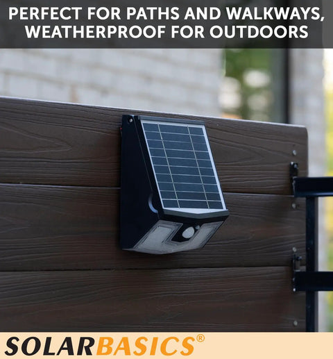 Two Pack Solar Security Lights With Motion Sensor, Waterproof Outdoor LED 700 Lumen Bright White, mounted on wooden fence