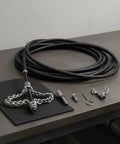 Heavy Duty Flexible Chain Knocker Drain Snake Auger With Solid Steel Core to knock out stubborn clogs and scale buildup laid on a table.