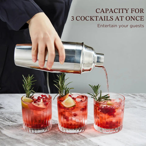 24 Ounce Cocktail Shaker Set With Bar Quality Strainer, Measuring Jigger, Mixing Spoon And Easy Recipe Guide For Beginners, Pro Grade Home Bar Kit In Silver in use pouring three cocktails