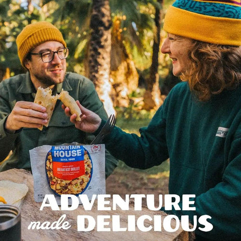 Camping scene with people enjoying Buffalo Style Chicken Mac And Cheese Freeze Dried Camping Meal With 12 Servings And 30 Year Shelf Life
