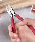 Person using 6 inch ultra sharp side cutter snips with extra long flush cutting edge for clean flat cuts, cutting copper wire