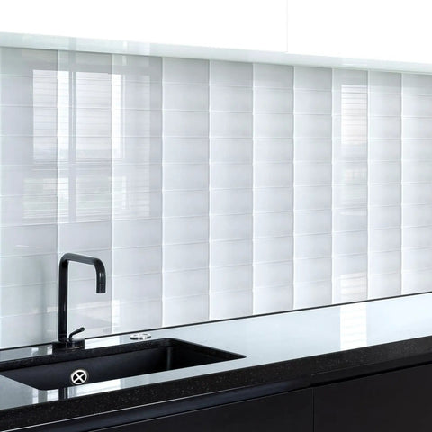 Easy DIY Peel and Stick Glass Backsplash Tiles for Kitchen or Bathroom, Subway White 3x6 Inch Glass Tiles installed above a black countertop