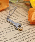 Mechanic Wrench Cremation Urn Necklace For Ashes Holder Pendant Spanner Memorial Keepsake For Dad Engraved Stainless Steel Jewelry With Secure Seal And Rubber Gasket Safe Ash Storage Gift on book with flowers