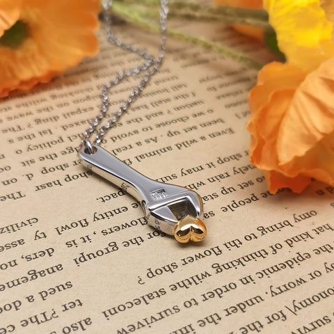 Mechanic Wrench Cremation Urn Necklace For Ashes Holder Pendant Spanner Memorial Keepsake For Dad Engraved Stainless Steel Jewelry With Secure Seal And Rubber Gasket Safe Ash Storage Gift on book with flowers