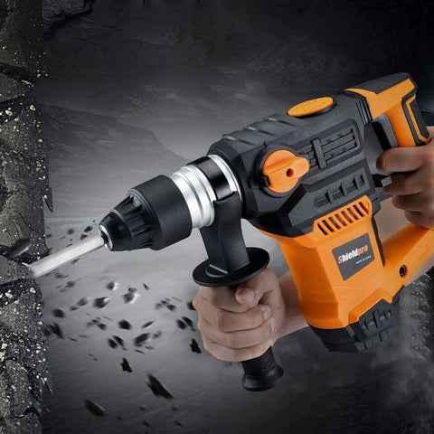 Powerful 13 Amp SDS Plus Rotary Hammer Drill 1-1/4 Inch in use on concrete wall, showing orange body and drill bit, Beast Mode Tough