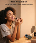 Woman using Go-To Portable Waist And Neck Cooling Fan With 10000mAh battery in a vanity setting