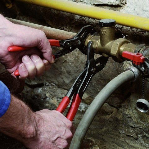 Using Cobra Locking Pliers Set Two Piece With Fine Adjustment For Different Sized Workpieces on plumbing pipe.