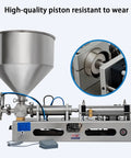 Close-up of Bulletproof Pneumatic Bottle Filler Machine with stainless steel piston and hopper for liquids and pastes.