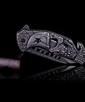 Pocket Folding Knife With 3D Skull Embossed Handle And Razor Sharp 440 Stainless Steel Blade, closed view on black background.