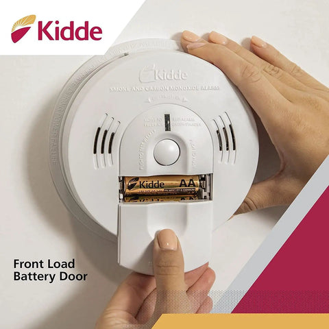 Close-up of hardwired smoke and carbon monoxide detector with open battery door and Kidde branding