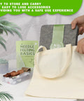 Person placing Dope Pro Grade Needle Felting Kit with 90 felting needles, 8x10 large mat, canvas bag and tools on table