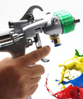 Pro Level Double Head Pneumatic Spray Gun With Stainless Steel Needle And Nozzle For Heavy Duty Industrial Painting Projects Featuring Tough As Nails Durability And Slick One Point Three Mm Tip Design held in hand, showcasing dual nozzle and colorful paint splashes.