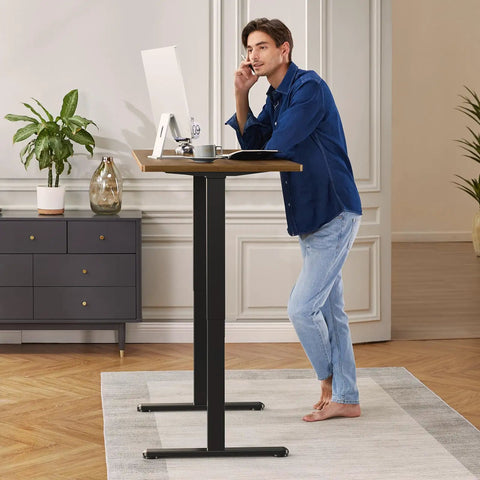 Person using a modern workspace with Beefy Dual Motor Standing Desk Frame With Electric Adjustable Legs For 44 To 90 Inch Desktops