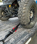 Close-up of UTV tire secured on trailer using Ultimate UTV Tie Down Kit For Trailer Transport With Tire Bonnets, showcasing the installation.