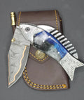 Fish Style Folding Knife With Ladder Pattern Damascus Blade And Blue Resin Handle, Brass Engraved EDC Knife, on leather sheath