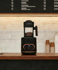Electric Coffee Bean Roaster Machine For Home Kitchen Using 1500W Motor And Quick Heat Function on kitchen counter with coffee beans.