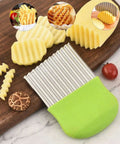 Crinkle cutter knife with green handle and stainless steel ribbed blade for crinkle-cut fries and vegetables