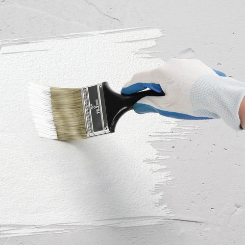 Hand using 9 Pack Flat Paint Brush Set For Walls And DIY Projects 2 Inch 3 Inch 4 Inch Brushes with soft rayon bristles on a wall