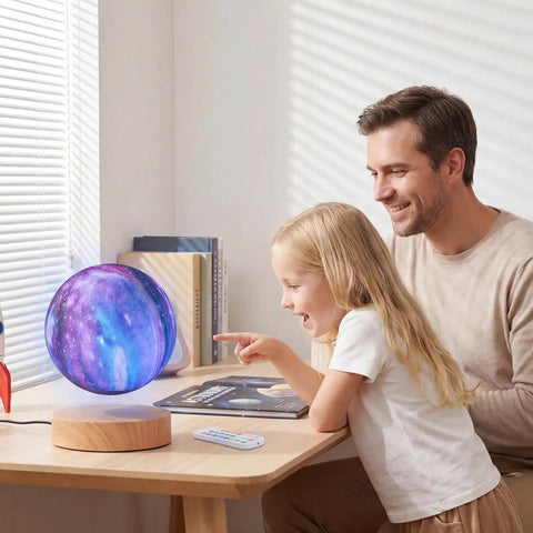 Father and daughter enjoy Levitating Moon Lamp 5.9 Inch Magnetic Floating Moon Light With Remote 3D Galaxy Moon Lamp on wooden desk.