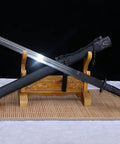 Beefy Damascus Tang Dao Sword With Black Gold Finish Hand Forged In China Real Premium Blade displayed on wooden stand