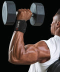 Man lifting dumbbell with weightlifting wrist wraps for heavier lifts 18 inch and 12 inch premium wrist support straps.