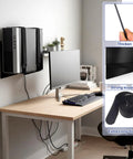Universal PC Wall Mount Rock Solid Metal Support Bracket For Desktop Towers And CPUs showing PC mounted with straps behind monitor.