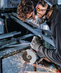 Worker using angle grinder with Pack Of 10 Pro Grade Straight Cutting Discs 115 Mm For Inox X Lock Bore 22.23 Mm 1 Mm Thick Standard