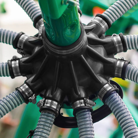Close-up of stainless steel hose clamps securing hoses in a mechanical setup, ideal for plumbing and automotive projects.