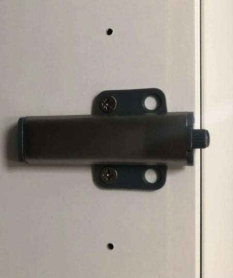 Super Slick Push To Open Cabinet Latches With Strong Magnet Set Of 3 Silver Touch Release Handles mounted on cabinet door.
