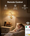 Wireless Boho Rattan Wall Sconce Set of Two, Stepless Dimming and Magnetic Mount, Rechargeable LED Lights, Sleek Brass Finish illuminating a bedside.