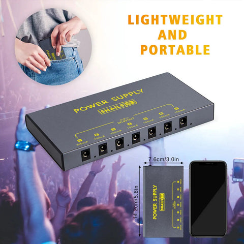 Portable Guitar Pedal Power Supply With Seven Isolated DC Outputs And Built In 3.7V 10000mAh Battery next to phone and pocket.