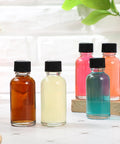 Clear Boston Round Glass Bottles With Black Screw Cap, One Oz Capacity, Complete Kit With Seventy Two Self Stick Labels, Four Precision Funnels, And Fine Liner For Slick DIY Blending, No Fuss Organization, And Totally Solid Storage Set in varying colors.