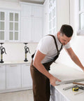 Two MANQO cabinet jacks on kitchen counter; adjustable 12.6–23.6 in, 156 lb capacity, 2-piece set.