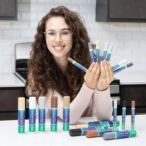 Person holding various color grout pens with Beige Tile Grout Pen For Waterproof Grout Paint And Sealer Colorant in focus.