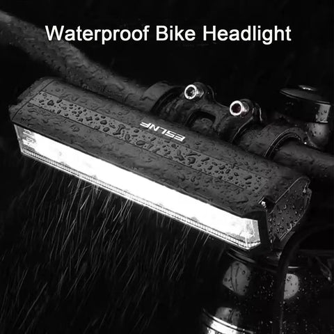 Ultra Bright 1800 Lumen Bike Light With Five Modes, USB Rechargeable Front Headlight mounted on bike, wet from rain.