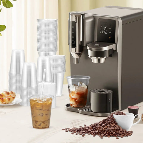 Coffee machine beside stacks of 100 Pack 16 Oz Clear Plastic Cups With Lids And Straws, iced coffee in foreground