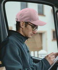 Man wearing Omnia Vincit Pink Breathable Hat For Women With Adjustable Buckle Everyday Wear Cap inside vehicle