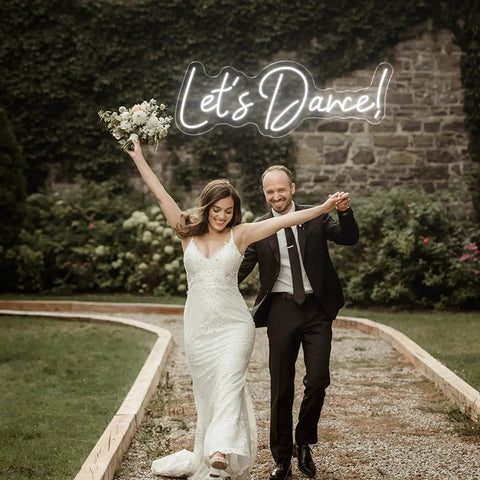 Lit Neon LED Sign For Wall Decor Light Up Word Sign With Bright LED Letters for a wedding with 'Let's Dance!' above couple