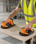 TorqTac 10 Inch Electric Vacuum Suction Cup Lifter With 662 Lbs Heavy Duty Load Capacity For Fast One Button Tile Stone Glass Handling And Moving in use on a wooden slab.