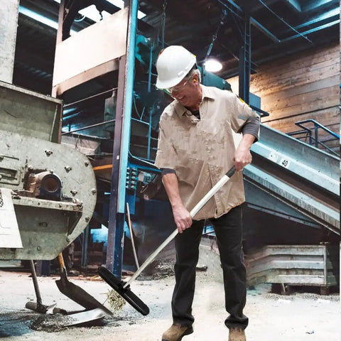 Man using Heavy Duty Telescoping Magnetic Pick Up Tool 27 To 44 Inches, 57 Lb Pull Magnetic Nail Sweeper in industrial setting.