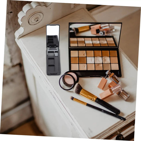 Dope New Compact Travel Makeup Palette With Mirror, Four Pack Empty Eyeshadow Containers For Portable Cosmetic Refills And Fly On The Go Beauty Organizers on a wooden surface.