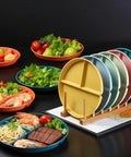 Eight Pack 9 Inch Divided Plates With Spoons Set Colorful Stackable Portion Control Dinner Plates on a rack, with food